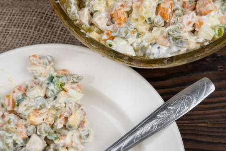 Russian traditional Olivier salad with vegetables and meat. Winter salad for New Year and Christmas. close up, selective focusの写真素材