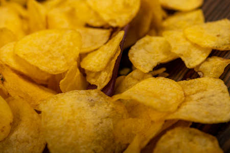 Potato chips scattered on the table, close-up, selective focusの写真素材