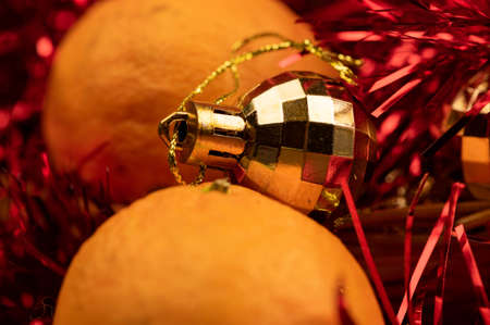 New Year and Christmas decorations of the festive table with tangerines, tinsel and Christmas balls. Close up, selective focusの写真素材