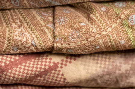 Pieces of fabric with different patterns, stacked. Close-up, selective focus.の写真素材