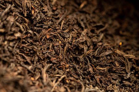 Large-leaved black tea in bulk on the table. Close-up of the surface textureの写真素材