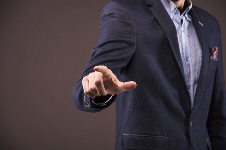 Man in a suit presses the finger on the displayの写真素材