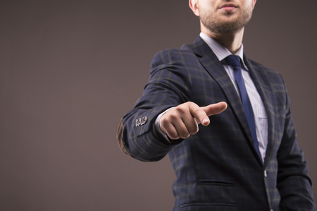 Man in a suit presses the finger on the displayの写真素材