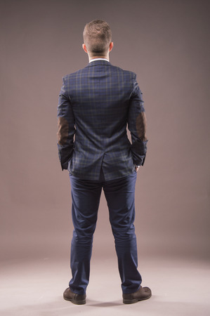 Man stands with his back to the camera and looking at somethingの写真素材