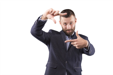 Business man looking at the camera through the frameの写真素材