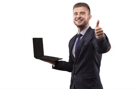 Man in suit with laptop in his hands shows OK signの写真素材