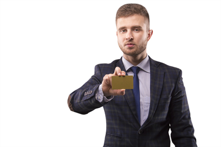 Handsome man in a suit holding a business card gold colorの写真素材