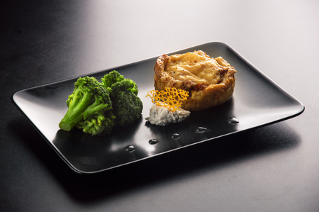 Delicious chopped steak from chicken fillet in addition to broccoli and tender cheese sauceの写真素材