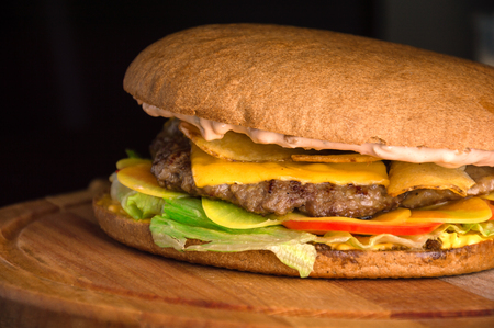 A hearty cheeseburger with beef chops and a garlic sauceの写真素材
