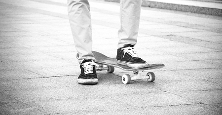 The guy in the sneakers put his foot on the skateboard and waits for a signal to startの写真素材