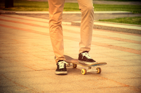 The guy in the sneakers put his foot on the skateboard and waits for a signal to startの写真素材