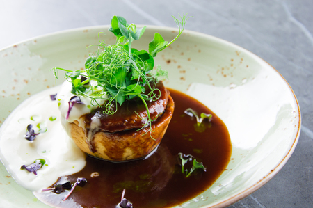Delicious French delicacy served on an elegant plate with two kinds of saucesの写真素材