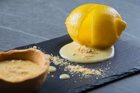 Delicious French dessert cooked in lemon. Cream filling flows directly from insideの写真素材