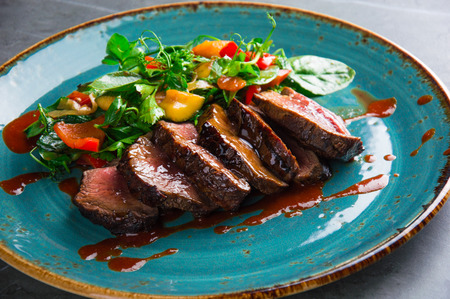 Juicy Skirt steak in addition with a vegetable garnish. Dish from the chefの写真素材