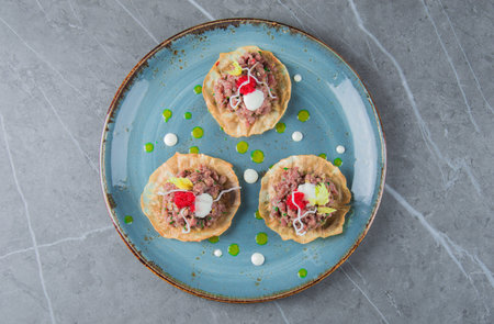 Set of delicious and tender tartlets with tartare. View from above