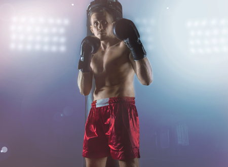 Professional boxer stands in the ring, the lights burn. Mixed mediaの写真素材