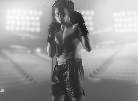 Professional boxer stands in the ring, the lights burn. Mixed mediaの写真素材