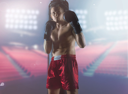 Professional boxer stands in the ring, the lights burn. Mixed mediaの写真素材