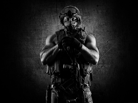 The soldier of the special unit stands with an automatic weapon at the advantage. Mixed mediaの写真素材