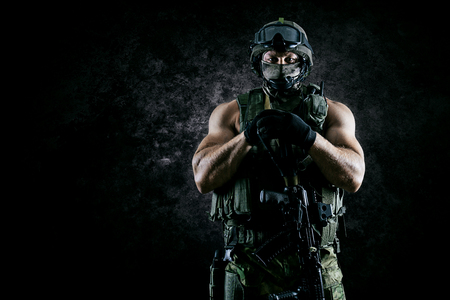 The soldier of the special unit stands with an automatic weapon at the advantage. Mixed mediaの写真素材