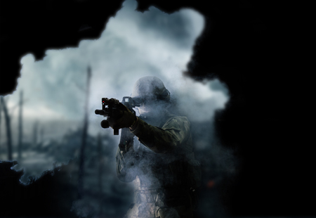 American soldier in combat ammunition with weapon in the hands of equipped laser sights is in battle order. Mixed mediaの写真素材