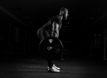 The weightlifter performs an exercise called deadlift. He fixed the weightの写真素材