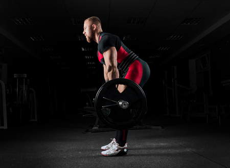 The weightlifter performs an exercise called deadlift. He fixed the weightの写真素材