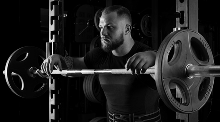 The weightlifter is near the bar, put his hands on it for a respiteの写真素材