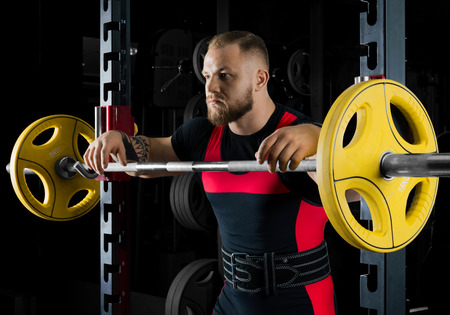 The weightlifter is near the bar, put his hands on it for a respiteの写真素材