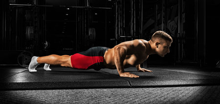 The athlete is stretched on a special cover in the gym. Side view