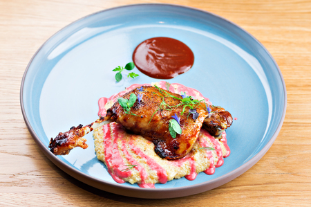 Juicy roasted duck leg confit with garnish. Mixed mediaの写真素材