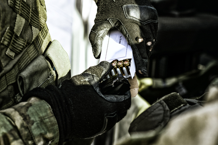 The fighter prepares a clip with bullets before the next fight. Mixed mediaの写真素材