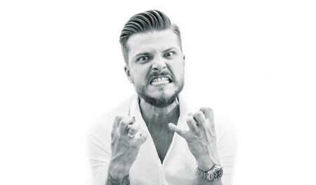 Aggressive man angrily looks at the camera. The concept of failure, psychological problems, personality disorder, poor employees. Mixed mediaの写真素材