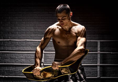 Professional boxer breaks an opponentâs belt after a match. The concept of success, sport, victory. Mixed mediaの写真素材