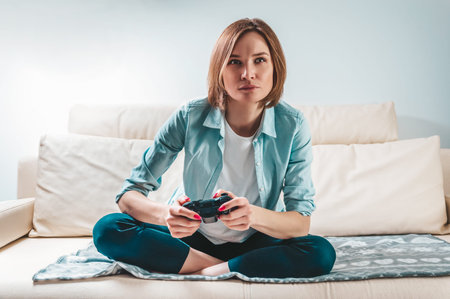 Portrait of a girl with a joystick in her hands. The concept of video games, computer consoles. Stay...