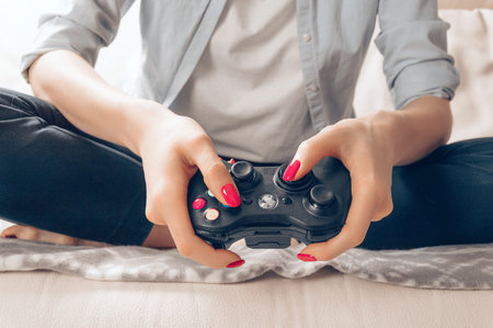 Image of hands holding a game joystick. Game concept. Stay home. Mixed media