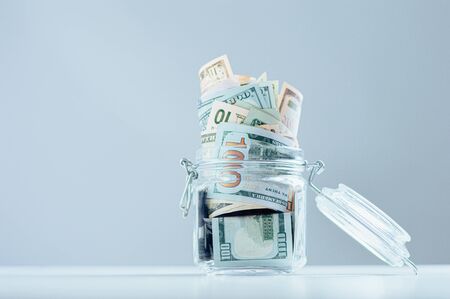 Glass jar full of money. Crisis Savings Concept. Mixed mediaの写真素材