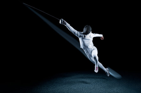 The fencer moves forward with a sword in his hand. Sport concept. Mixed media