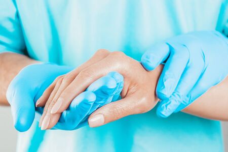 The doctor carefully holds the patientâs hand. Medical concept. Mixed mediaの写真素材