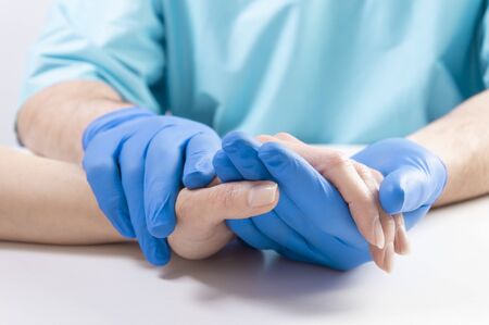 The doctor carefully holds the patientâs hand. Medical concept. Mixed mediaの写真素材