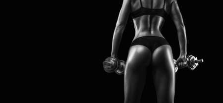 Image of a female athlete with dumbbells. Back view. Bodybuilding and fitness concept. Mixed mediaの写真素材
