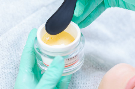 Image of a jar with a yellow mask for skin care. Concept for beauty salons. Mixed mediaの写真素材