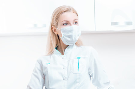 Portrait of a girl in a protective mask. Concept of cosmetology, plastic surgery, beauty industry. Mixed mediaの写真素材