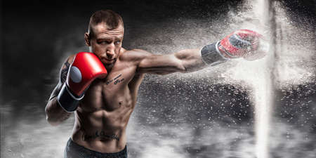 Professional boxer breaks the barrier with a glove. Dust and debris spilled over. 3d rendering. Sports concept. Mixed mediaの写真素材