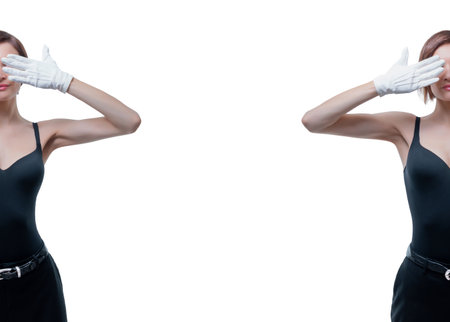 Beautiful young woman in white gloves covered her eyes with her hands. Mixed mediaの写真素材