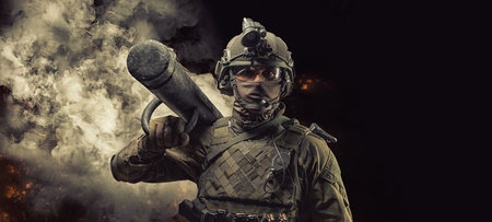 Portrait of a Special Forces soldier with an assault ram on his shoulder. SWAT concept. Anti-terrorism, fight against crime. Mixed mediaの写真素材