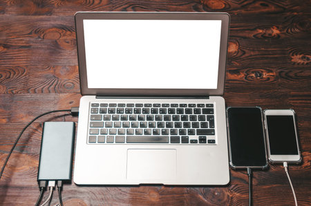 Set of gadgets. Laptop two smartphones and a powerbank. Programmer workplace concept. Top view. IT...
