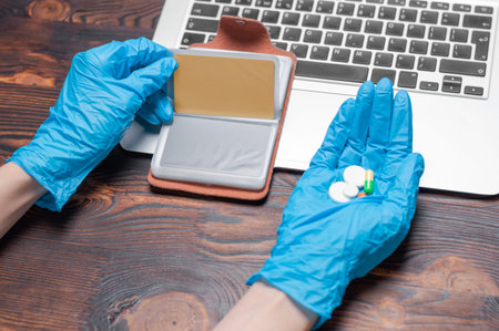 Image of laptop, bank gold card, pills and protection equipment. Health insurance concept. The medicine. Mixed mediaの写真素材