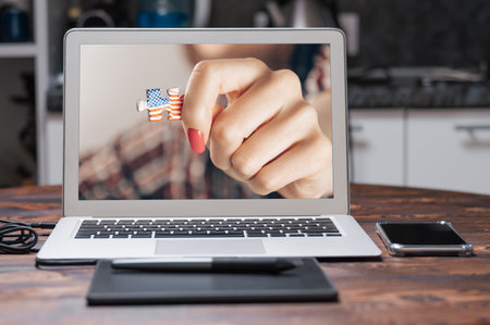 Portrait of a girl holding a puzzle with the USA flag. Concept of emigration, work and travel. Obtaining a visa and citizenship. Mixed mediaの写真素材
