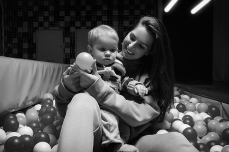 Beautiful woman plays with a baby girl in a dry pool. Holiday concept. Entertainment malls....